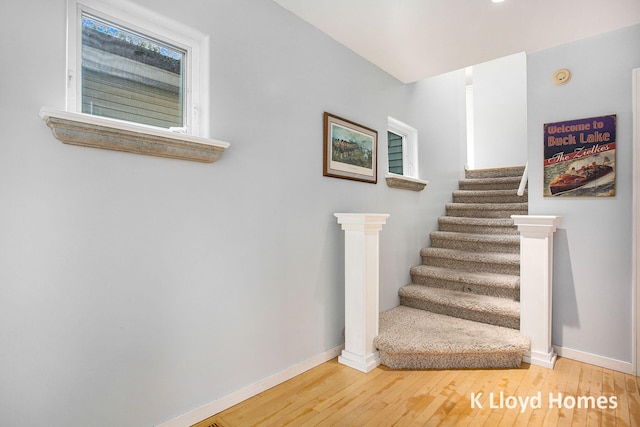 staircase with hardwood / wood-style flooring