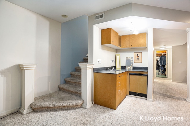 kitchen with light carpet, dishwasher, and sink