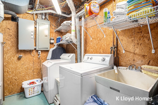 laundry room with electric panel, independent washer and dryer, and sink