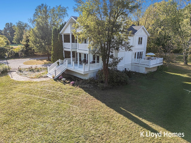 view of front of property with a deck and a front lawn