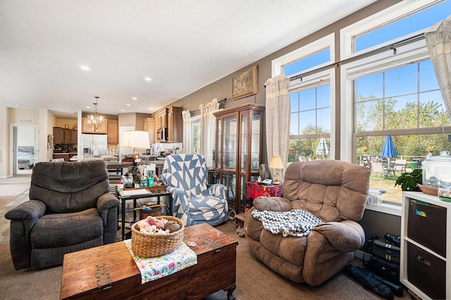 living room featuring light colored carpet and a chandelier