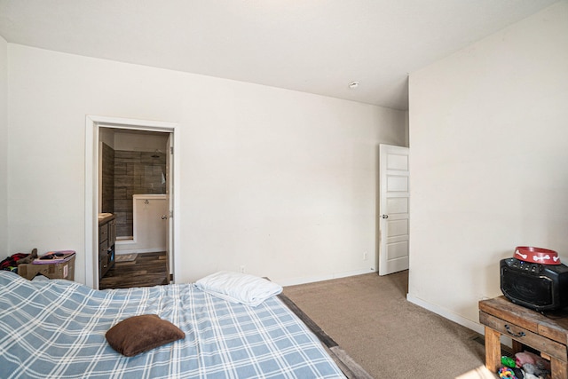 carpeted bedroom featuring ensuite bath