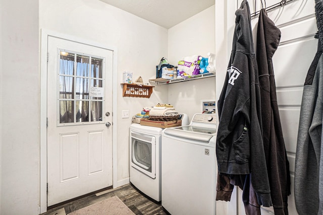 laundry room with dark wood-type flooring and washing machine and dryer