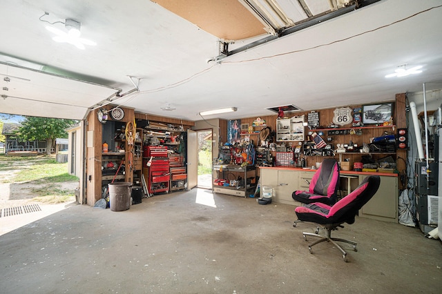 garage featuring a workshop area and wooden walls