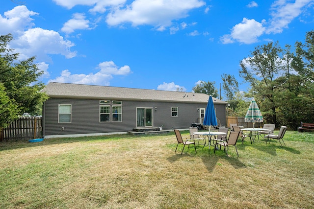 back of property featuring a lawn