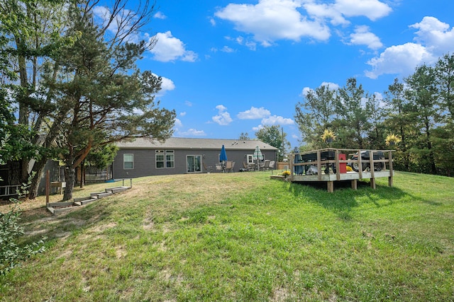 view of yard with a wooden deck