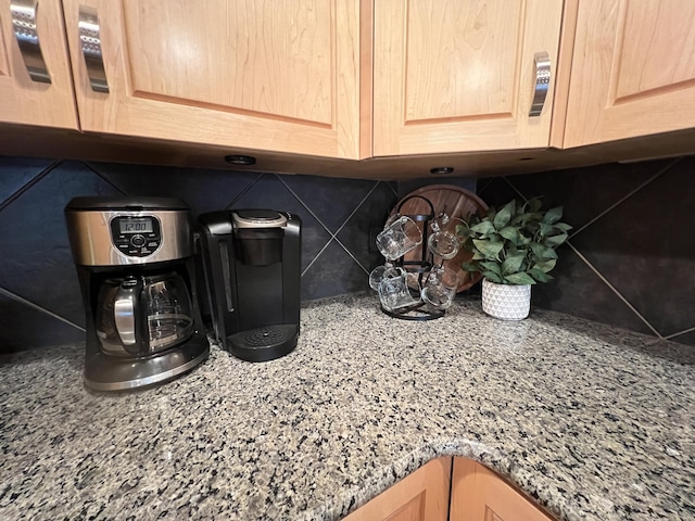 details featuring decorative backsplash, light brown cabinetry, and stone counters