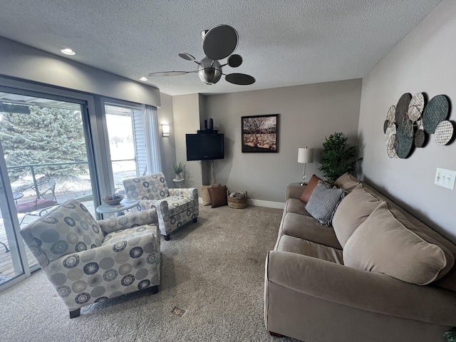 carpeted living room with a textured ceiling and ceiling fan