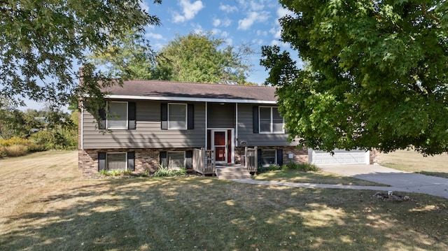 raised ranch with a garage and a front yard