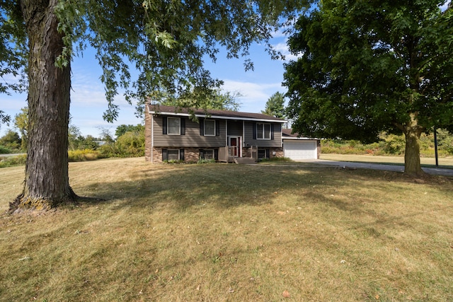 rear view of house featuring a lawn and a garage