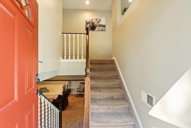 stairs featuring carpet flooring