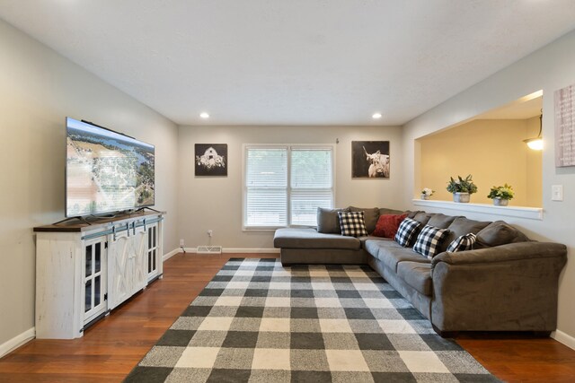 living room with dark hardwood / wood-style floors