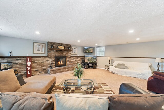 living room featuring a textured ceiling, carpet floors, and a fireplace