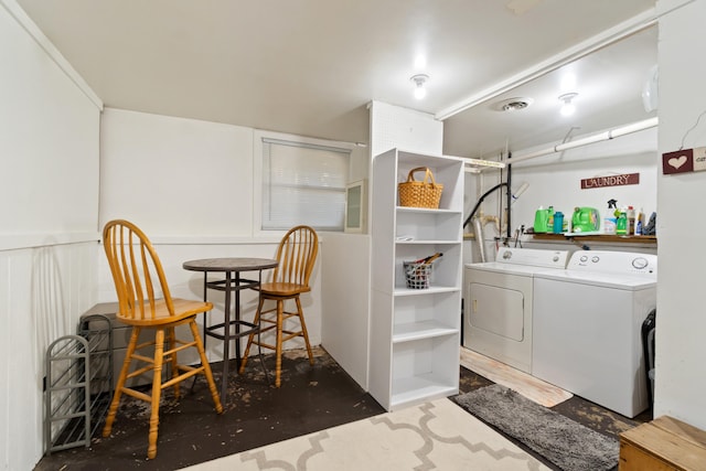 clothes washing area with washer and clothes dryer