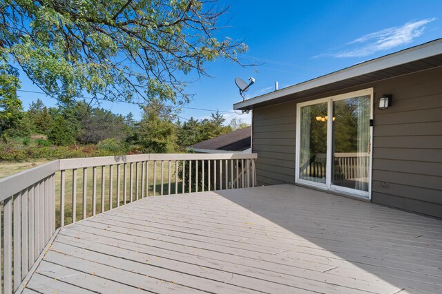 wooden terrace with a lawn