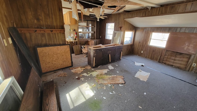 misc room featuring ceiling fan and wooden walls