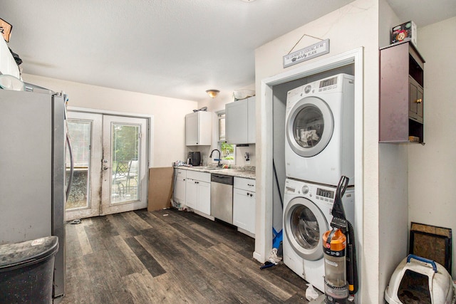 laundry room featuring french doors, sink, stacked washer / dryer, and dark hardwood / wood-style floors