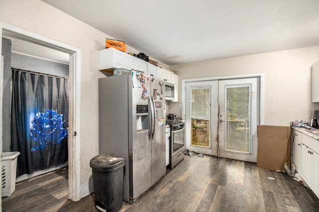 kitchen featuring appliances with stainless steel finishes, dark hardwood / wood-style floors, and white cabinetry