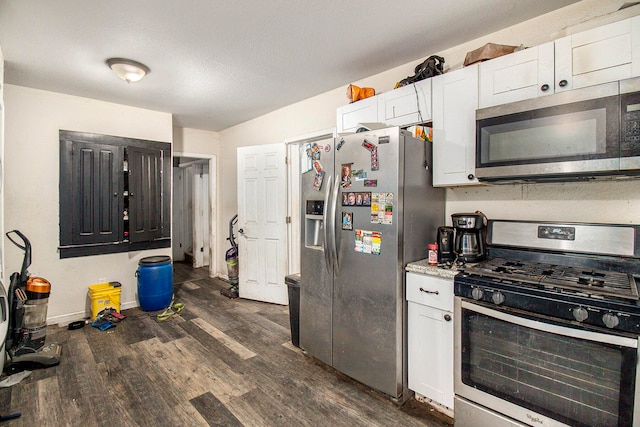 kitchen with white cabinets, stainless steel appliances, and dark hardwood / wood-style floors