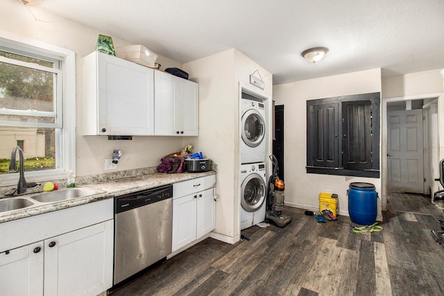 kitchen featuring white cabinets, dishwasher, stacked washer / drying machine, and sink