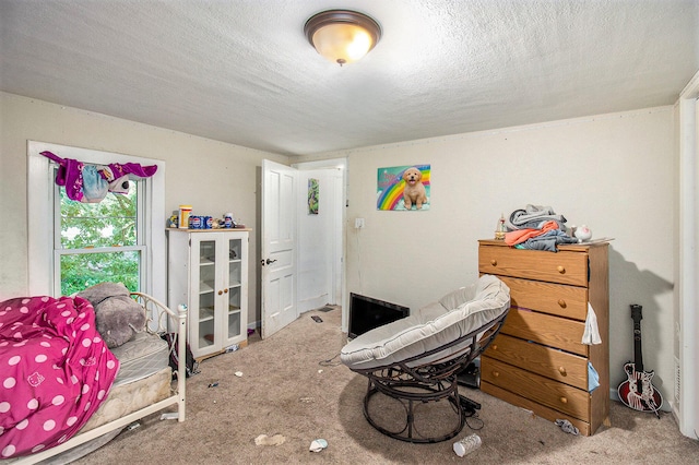 bedroom featuring a textured ceiling and carpet