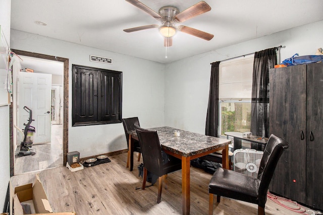 dining area featuring light hardwood / wood-style floors and ceiling fan