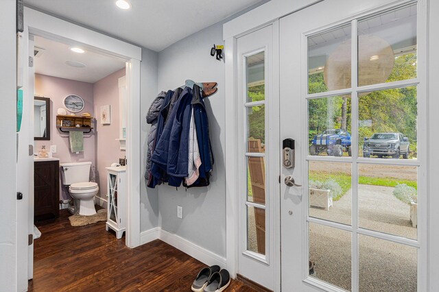 doorway to outside with plenty of natural light and dark hardwood / wood-style floors