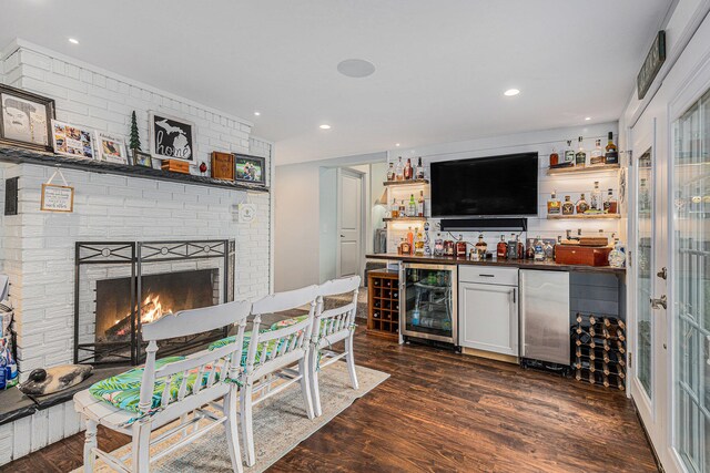 bar featuring white cabinets, beverage cooler, dark hardwood / wood-style floors, and stainless steel fridge