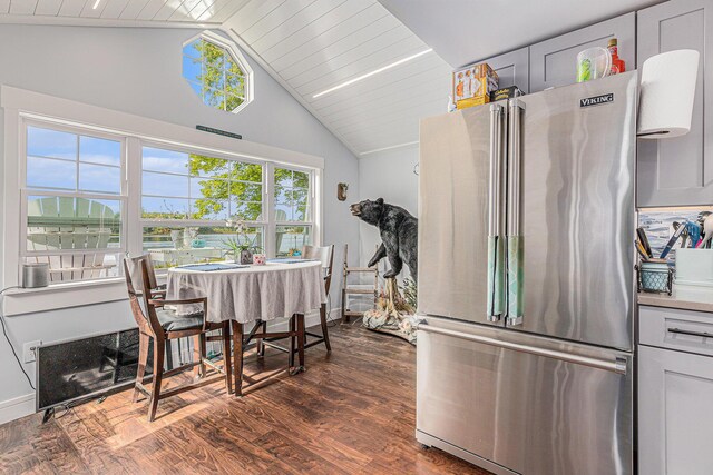 dining area featuring lofted ceiling, dark hardwood / wood-style floors, and wooden ceiling