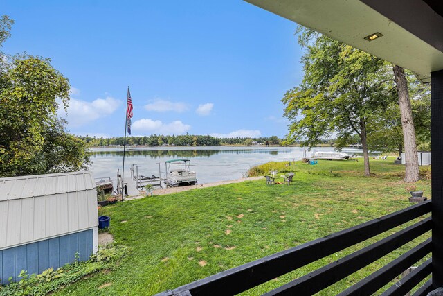 view of yard with a boat dock and a water view