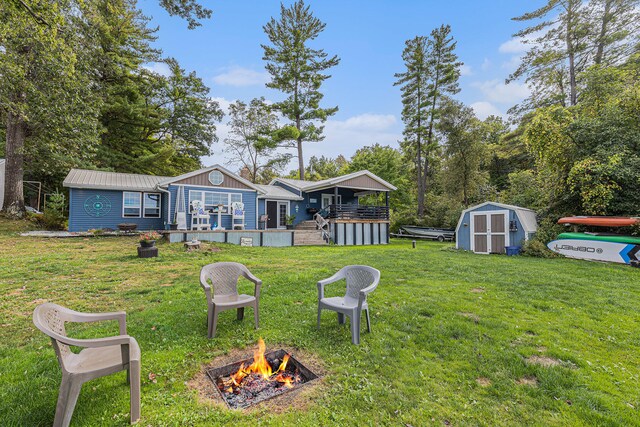 view of yard with a fire pit and a shed