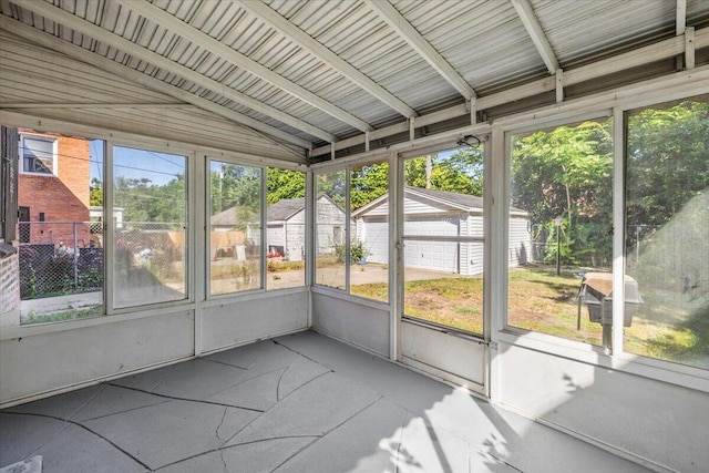 unfurnished sunroom with lofted ceiling