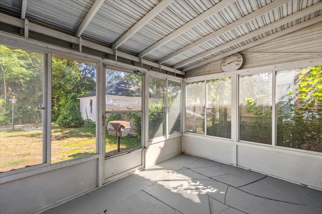 unfurnished sunroom with lofted ceiling