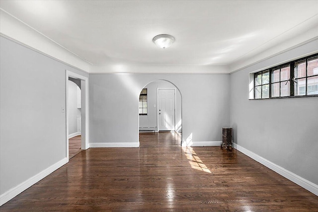 spare room with dark wood-type flooring