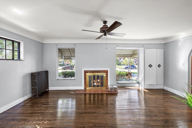 unfurnished living room featuring a healthy amount of sunlight, a fireplace, and ceiling fan