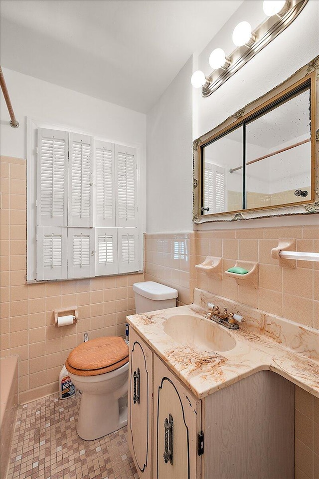 full bathroom with tile walls, tile patterned flooring, independent shower and bath, vanity, and toilet