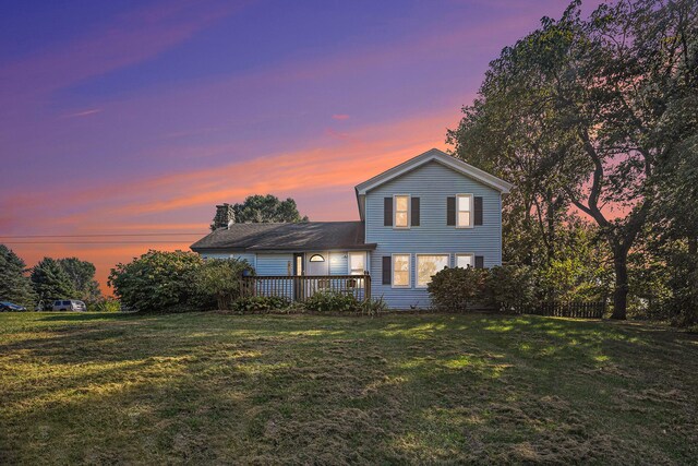 view of front of property with a lawn and a wooden deck