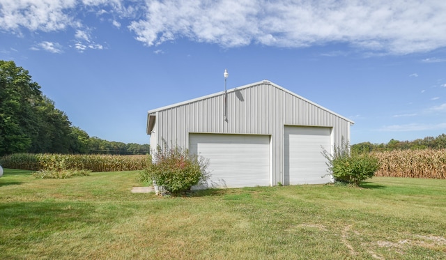 garage featuring a lawn