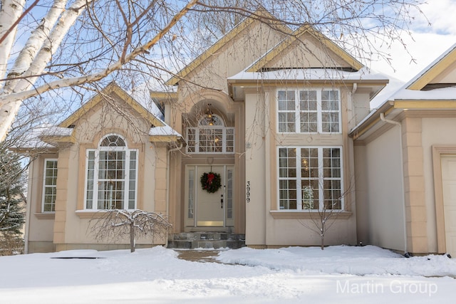 view of snow covered property entrance