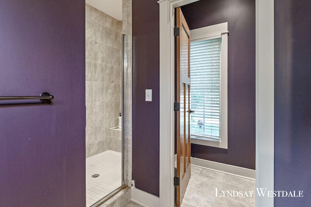 bathroom featuring tile patterned flooring and an enclosed shower