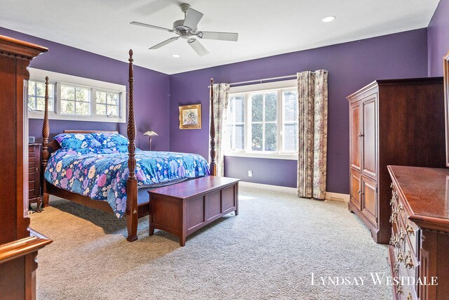 bedroom featuring multiple windows, light carpet, and ceiling fan