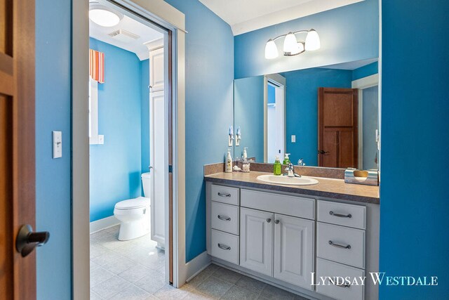 bathroom featuring vanity and toilet