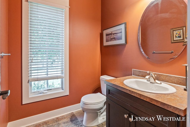 bathroom featuring vanity, tile patterned flooring, and toilet