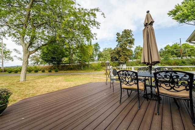 wooden terrace featuring a lawn