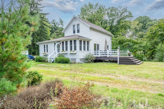 view of front facade featuring a front lawn and a deck