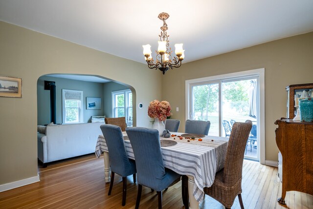 dining space featuring a notable chandelier, light hardwood / wood-style flooring, and a wealth of natural light