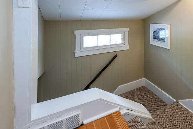 stairway with wood walls