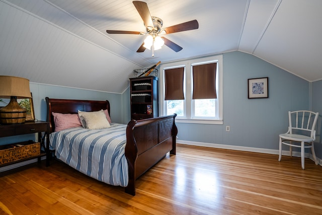 bedroom featuring light hardwood / wood-style floors, vaulted ceiling, and ceiling fan