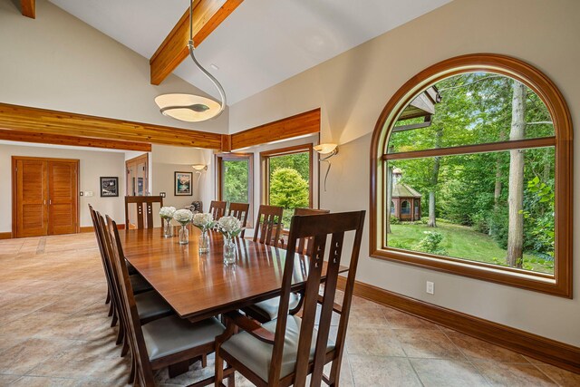 dining space with beamed ceiling, light tile patterned floors, and high vaulted ceiling