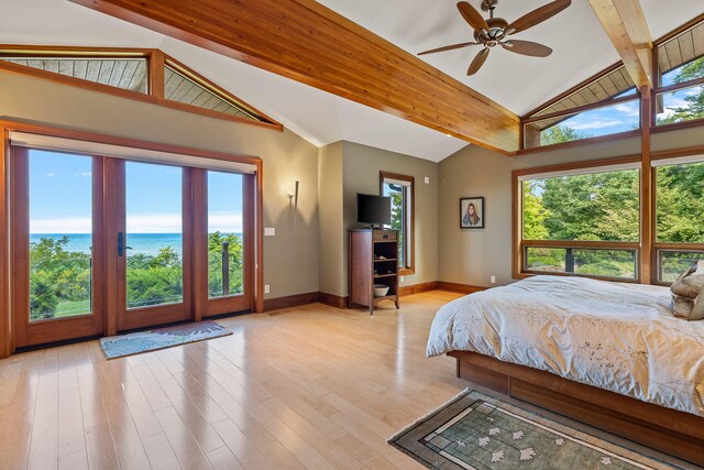 unfurnished bedroom featuring lofted ceiling with beams, light hardwood / wood-style floors, and ceiling fan